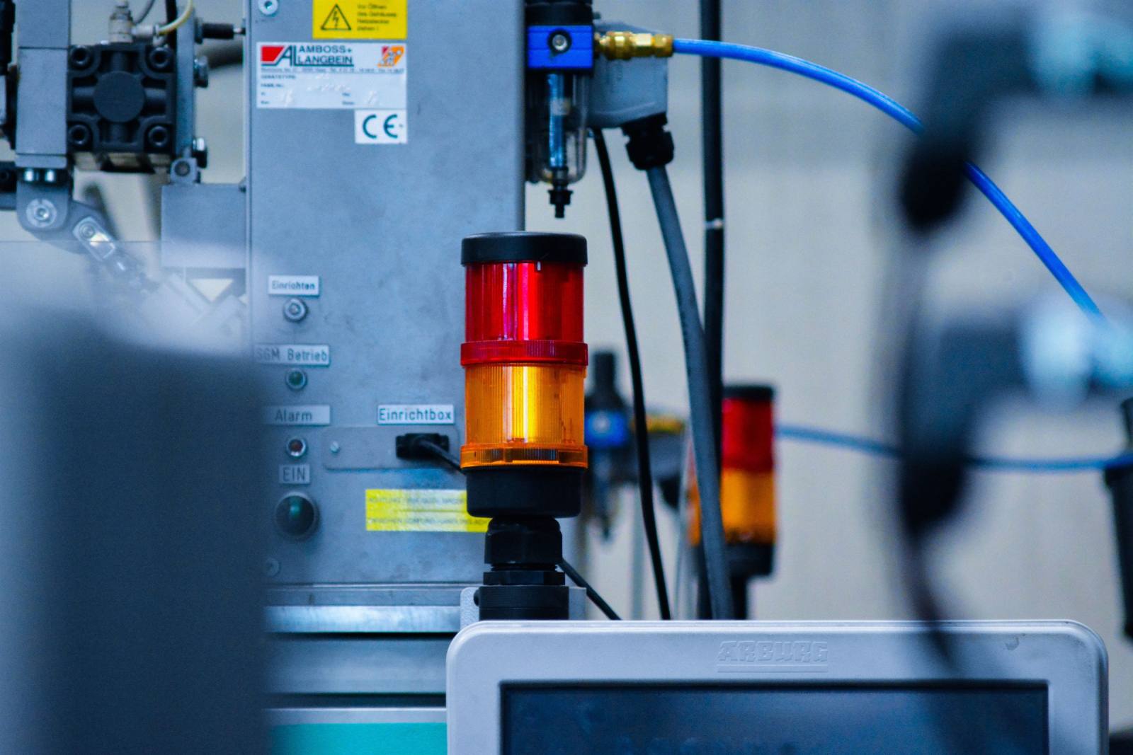 SENZAIT Industrial automation — close-up of modern industrial machinery on a production line.